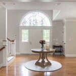 Front entrance with a triple-wide arched upper window.