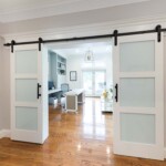 Country-themed barn door mounted double slider. Brings you into the spacious and well-lit office.