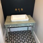 An elegant retro-art vanity combined with an old world, custom tile pattern illustrates the attention to detail the Corrigan designers employ in every room. No angle or space is untouched.